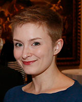 Portrait image of Caitlin Silberman smiling and wearing a blue shirt