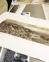 Image of a pile of black and white and sepia archival photographs