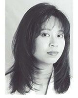 Closely-cropped black and white portrait image of Anne Cheng