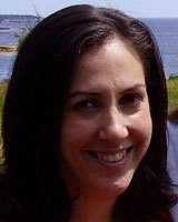 Closely cropped photograph of J.K. Barret with long brown hair outdoors