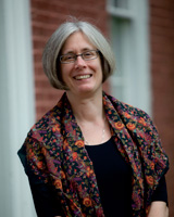 Portrait image of Mary Agnes Edsall outdoors wearing glasses and a flower-patterned shawl