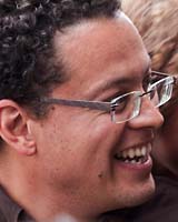 Closely cropped portrait of William Jones laughing and wearing glasses