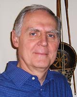 Portrait image of Karl Reichl wearing a blue button-ed up shirt