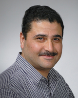 Portrait image of Manu P. Sobti wearing a checkered blue and white shirt