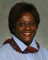 Portrait image of Norlisha Crawford wearing a blue shirt and dark scarf
