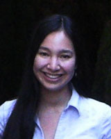 Portrait image of Beth Lew-Williams in front of a black background wearing a white shirt