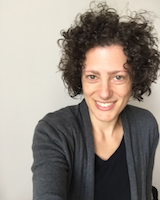 Portrait image of Samantha Herrick-a slightly off-center 'selfie' with Herrick wearing a black shirt and grey sweater