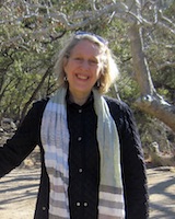 Portrait image of Anne Hansen outdoors wearing a dark shirt and light-colored scarf