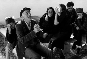 Black and white photograph by James Nachtwey of a family grieving and praying