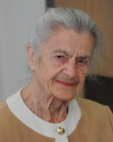 Portrait image of Ciplijauskaité wearing a tan and white shirt.