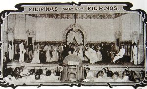 Black and white image with graphic frame depicting performers on a stage performing the zaruela "Filipinas para los Filipinos," which premiered in Manila in 1905.