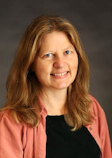 Portrait image of Celia Applegate wearing a salmon-colored shirt.