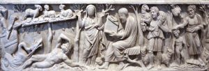 image of A sarcophagus, from Santa Maria Antiqua in Rome. Carved stone depicting multiple figures in greek robes, animals, and trees