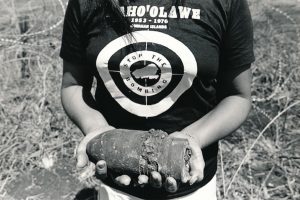 A member of the Protect Kahoʻolawe ʻOhana holds spent ammunition.