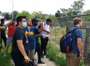 Image Description: UWM Buildings-Landscapes-Cultures Field School participants observing a community garden in Milwaukee’s Walnut Hill neighborhood.