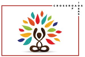 Image description: the Crosswords of Ideas graphic showing a person sitting on the ground with their hands up in the air and colorful leaves in an arch around them. It says "Crossroads of Ideas on the top right corner in crossword format. 
