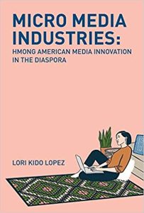 This is a book cover image that says "Micro Media Industries: Hmong American Media Innovation in the Diaspora" by Lori Kido Lopez. The cover is pink and at the bottom there is an illustration of a woman sitting on the floor with a laptop open in her lap.