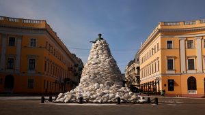 Photograph of the streets of Odesa, and a particular monument covered in sandbags.