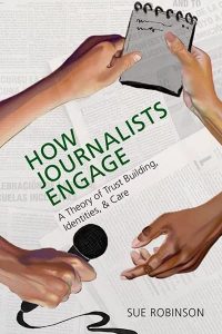 This is an image of the book over. There are four hands sharing a notebook and a microphone.