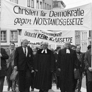 Protestant pastors participating in a protest on May 8, 1968, with signs reading “Christian for Democracy – Against Emergency Laws.”