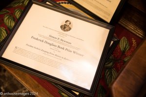 Image of Simon Newman's Frederick Douglas Book Prize in a black frame.
