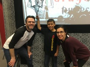 Jason Yancey and Esther Fernández pose with an audience member after a show. 
