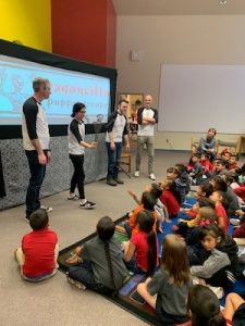 Members of Dragoncillo, Jared White, Esther Fernández, Jason Yancey, and Jonathan Wade share their enthusiasm for puppetry with an elementary school audience in El Paso, TX.