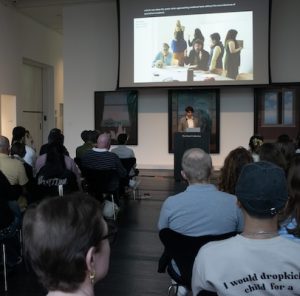 Image of Daniel Davies presenting at a podium at Space City Medievalism